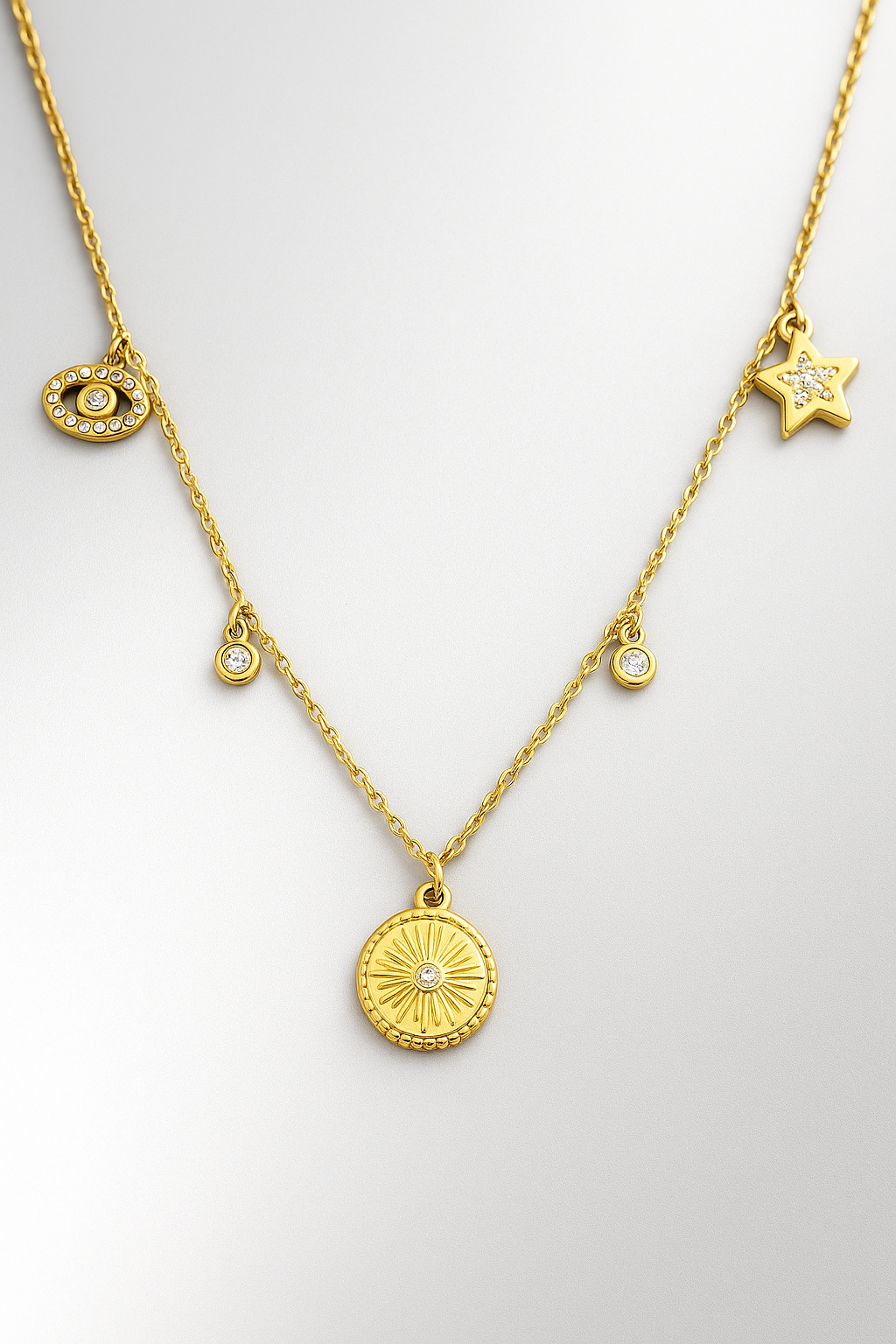 Gold Celestial Charm Necklace – Sun, Star & Evil Eye Pendant with Cubic Zirconia Accents LN10155